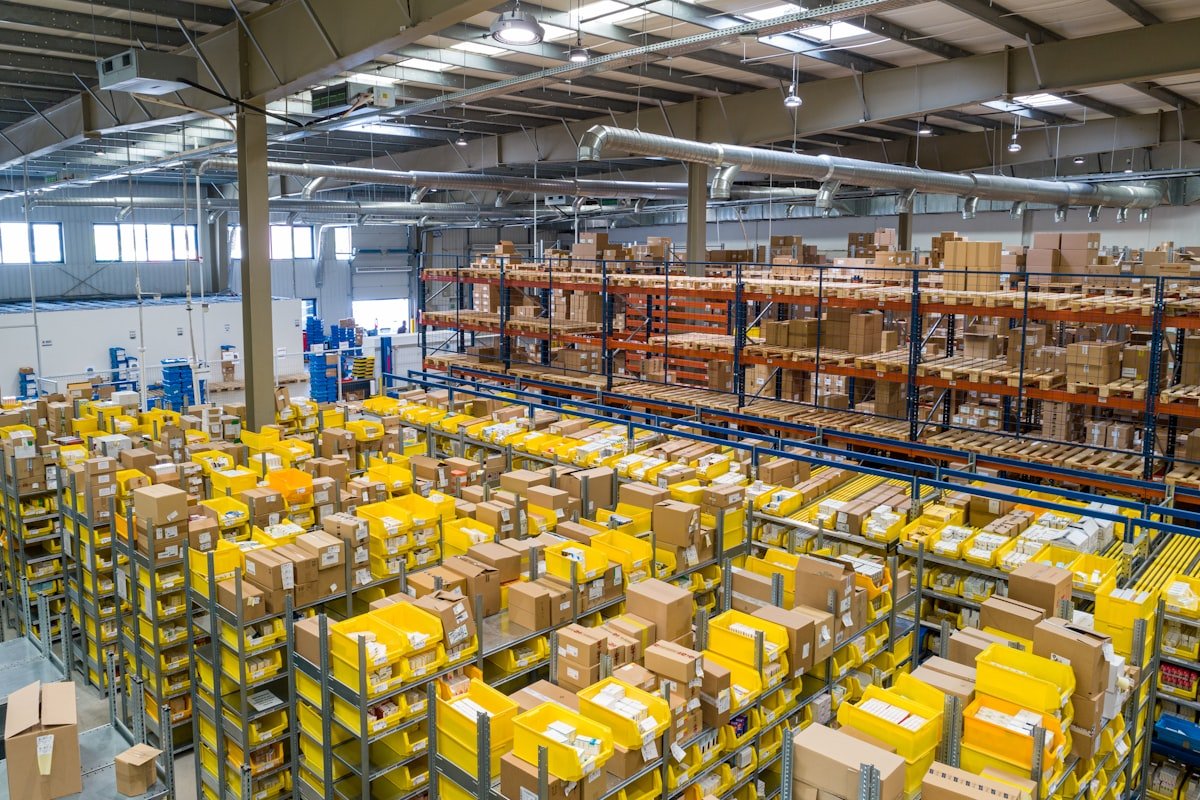 Warehouse interior with shelving and forklift moving inventory